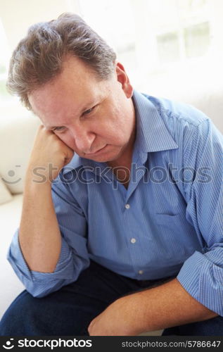 Depressed Overweight Man Sitting On Sofa