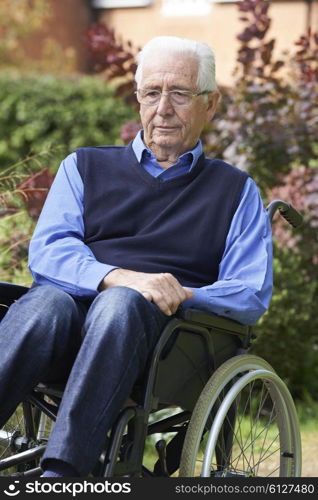 Depressed Senior Man Sitting Outdoors In Wheelchair