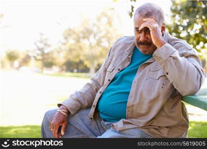 Depressed Senior Man Sitting Outside
