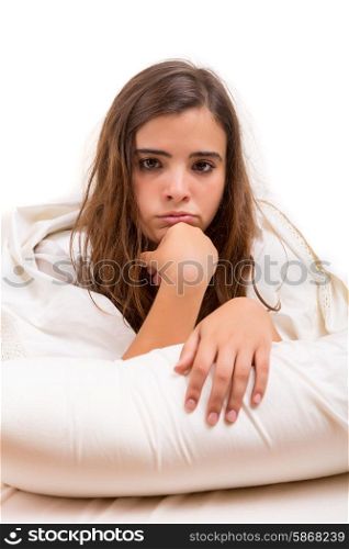 Depressed woman lying in bed, isolated over white