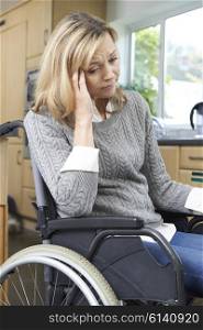 Depressed Woman Sitting In Wheelchair At Home