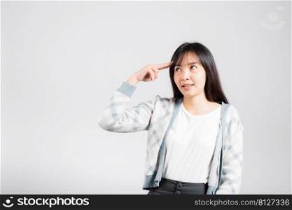 Depressed woman wanting shooting to kill herself by holding fingers on her head and looking away studio shot isolated white background, young female pointing fingers makes suicide gesture