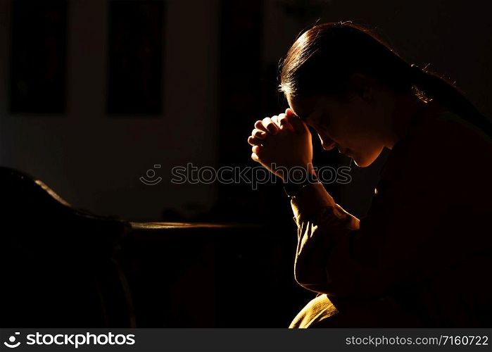 depressed women sitting in the low light church and praying, International Human Rights day concept