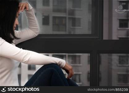 depressed women sitting near window, alone, sadness, emotional concept