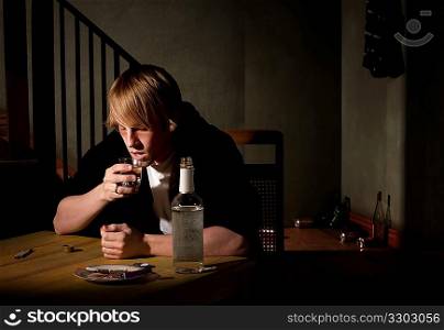 Depressed young man with alcohol