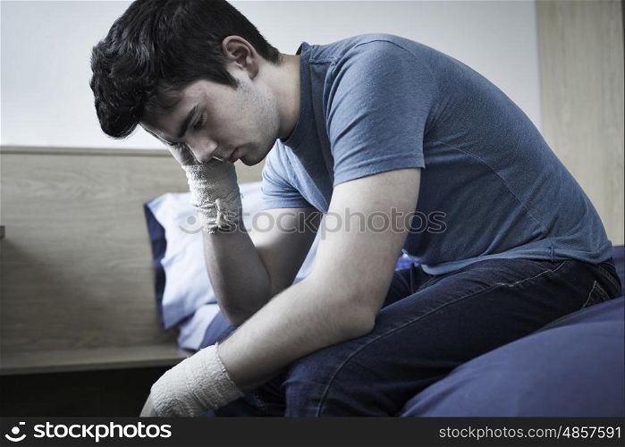 Depressed Young Man With Bandaged Wrists After Suicide Attempt