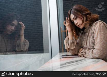 depressed young woman having headache, feeling sad, worry about problem