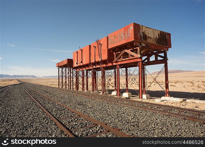 Derelict water tanks by the railroad tracks on the Railroad line to Luderitz from Aus.