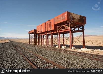 Derelict water tanks by the railroad tracks on the Railroad line to Luderitz from Aus.