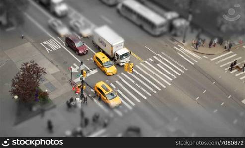 Desaturated tilt shift aerial view of a city intersection