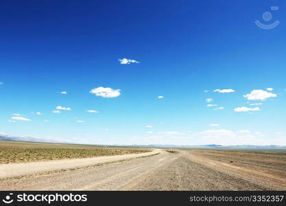 Desert road in Mongolia with dramatic sky