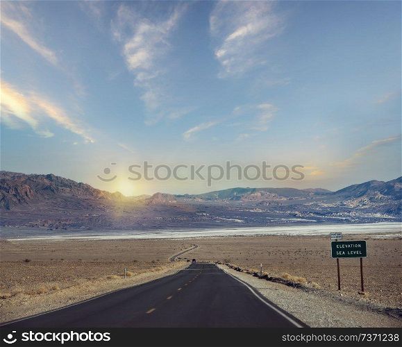 Desert road leading through Death Valley National Park, California USA.