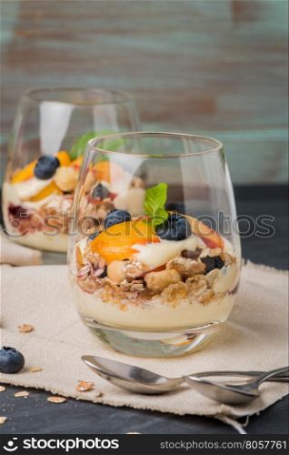Desert with whipped cream and peach on wooden table.