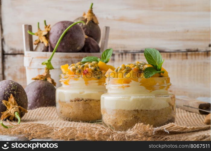 Desert with yogurt and passion fruit top on wooden table.