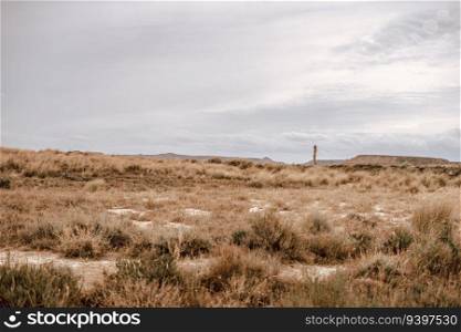 Desertic landscape and a woman on the Barcenas Reales desert in Navarra, Spain