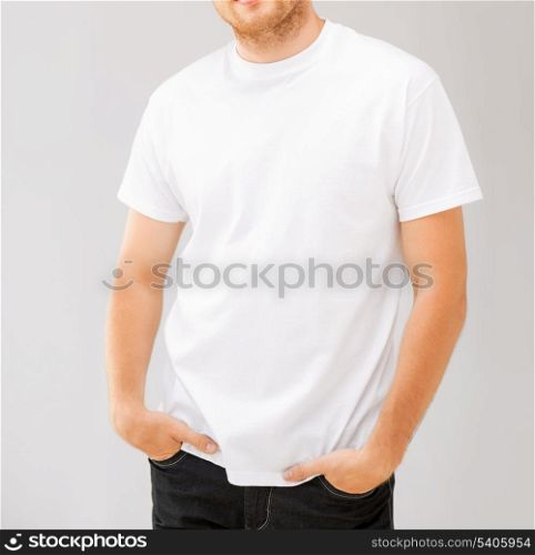 design and advertisement concept - picture of smiling man in blank white t-shirt