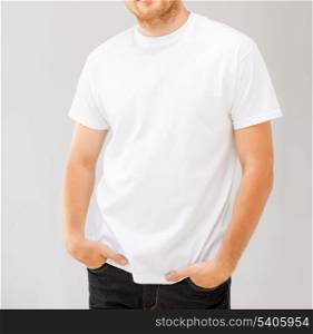 design and advertisement concept - picture of smiling man in blank white t-shirt