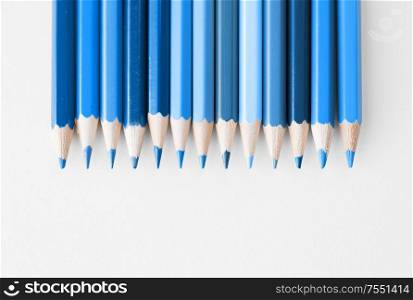 design and creativity concept - many pencils in different shades of color of the year 2020 classic blue. pencils in different shades of classic blue color