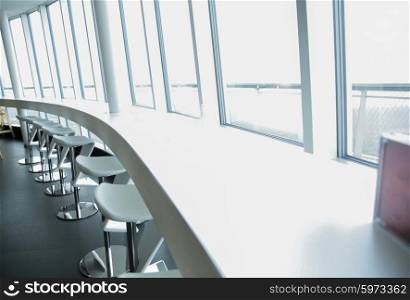 design, public place, furniture and interior concept - close up of restaurant interior with bar table and chairs