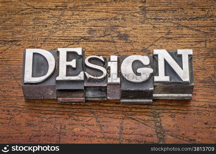 design word in mixed vintage metal type printing blocks over grunge wood