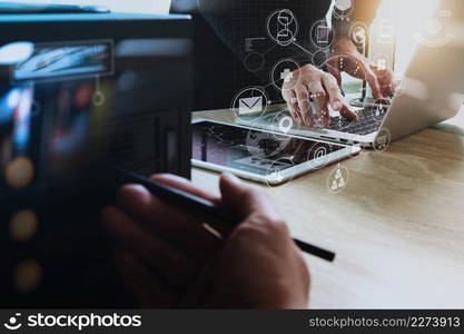 Designer Businessman hand using smart phone,mobile payments online shopping,omni channel,digital tablet docking keyboard computer in modern office on wooden desk,virtual interface icons screen