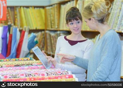 designer choosing fabric at haberdashery