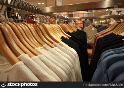 Designer clothes hanger in a row in a shop