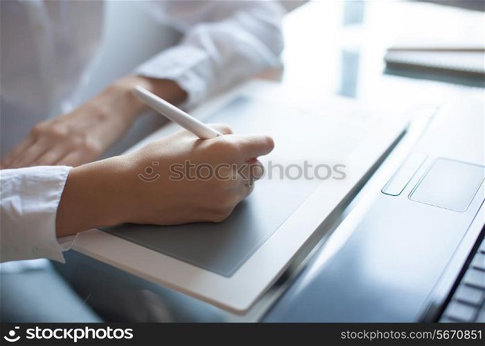 Designer girl drawing with graphics pad