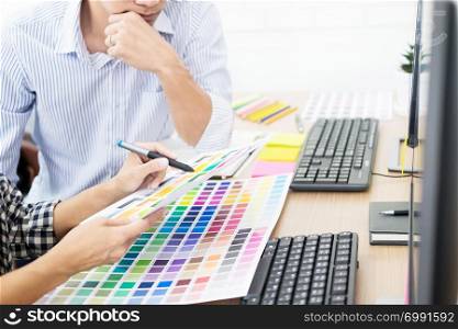 designer graphic creative creativity working together coloring using graphics tablet and a stylus at desk with colleague