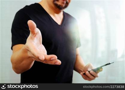 Designer hand pressing an imaginary button,open hand,holding smart phone,filter