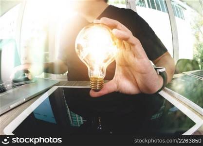 designer hand showing creative business strategy with light bulb as concept