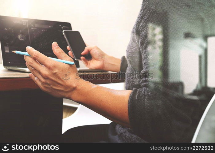 Designer hand using mobile payments online shopping,omni channel,in modern office wooden desk,filter effect