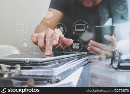 Designer hand using mobile payments online shopping,omni channel,in modern office wooden desk,icons graphic interface screen,eyeglass,filter