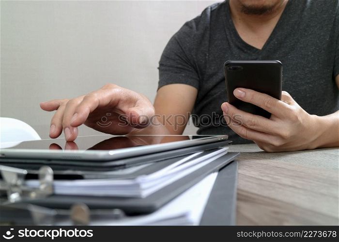 Designer hand using mobile payments online shopping,omni channel,in modern office wooden desk,icons graphic interface screen,eyeglass