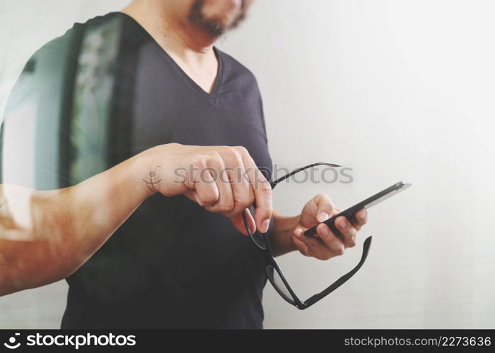 Designer hand with eyeglass using smart phone for mobile payments online shopping,omni channel,on white background,filter effefct