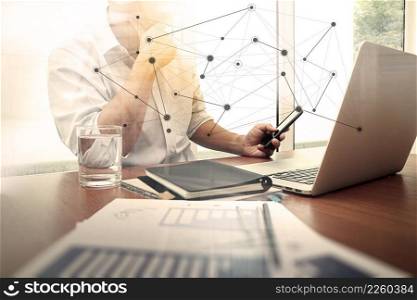  designer hand working and smart phone and laptop on wooden desk in office with london city background        
