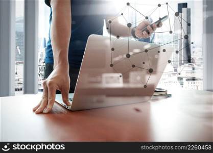 designer hand working and smart phone and laptop on wooden desk in office with london city background and social network diagram
