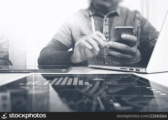 Designer hand working in creative studio. Using modern laptop digital tablet smart phone.responsive design website. Blurred background sun flare effect,horizontal mock up photo, black white