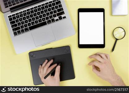 designer working graphic digital tablet with stylus yellow desk