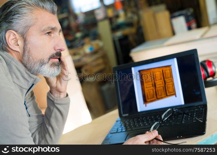 designer working on wooden table project