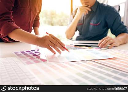 Designer working together and choosing colors in modern office.