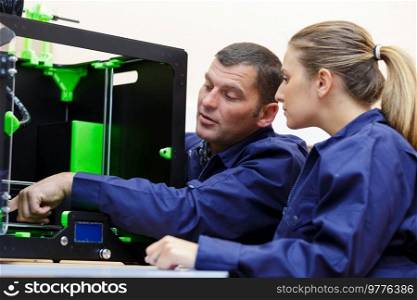 designers in modern laboratory and working with 3d printer