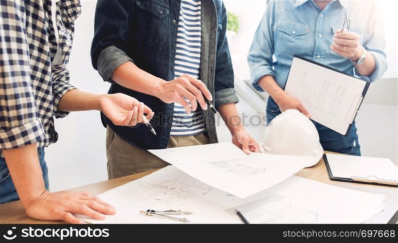 designers in the office are working Discussion Blueprint Architect on a new project Design Draw Teamwork on wooden desk