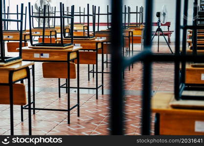 Desk and chairs in classroom at school