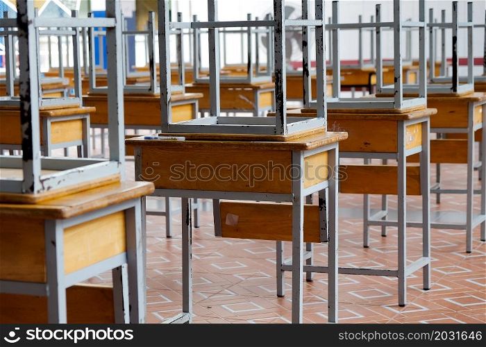 Desk and chairs in classroom at school
