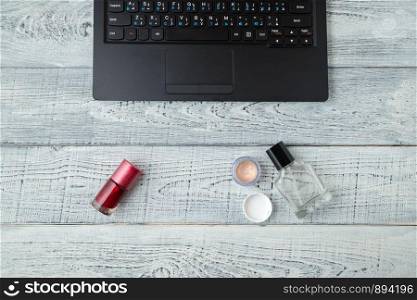 Desk. woman's workplace.laptop,perfume and cosmetics. the view from the top. flat lay