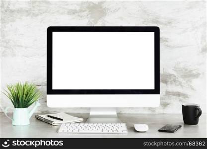 desktop computer on workspace table showing blank white screen