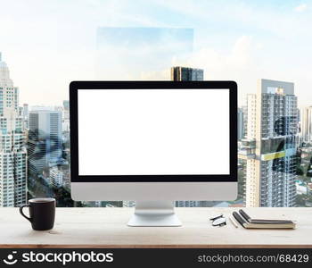 desktop computer white frame on work table in office place city background