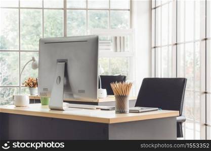 Desktop PC computers in small modern office or home office. Trendy workplace interior.