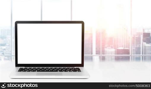 Desktop with panoramic view. Laptop on table in office with panoramic view of modern downtown skyscrapers at business district